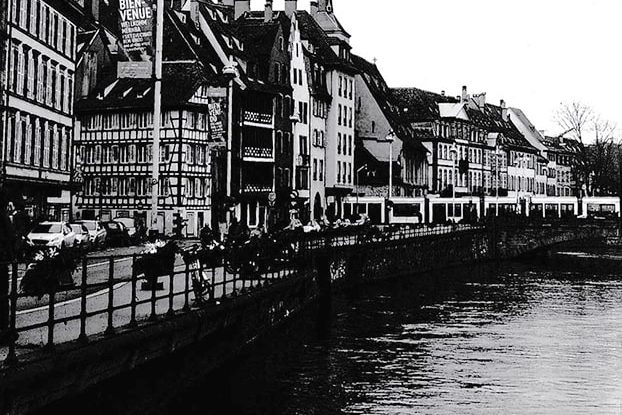 Street next to a river in Strasbourg in France with typical French architecture