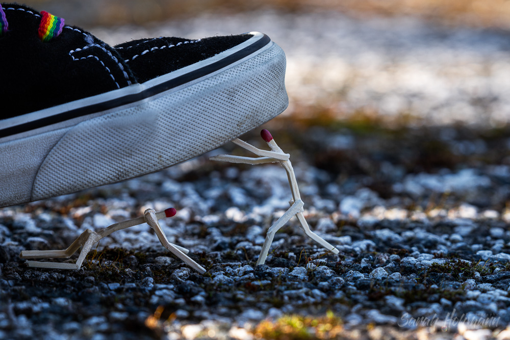 shoe with a rainbow lace and with match stick figures