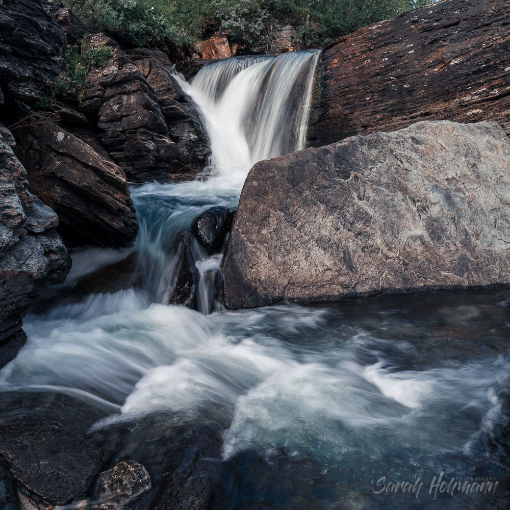 Waterfall flowing through boulders in swedish Lapland in summer